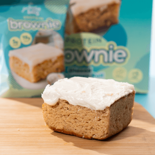 Delicious glazed cinnamon roll brownie with creamy frosting, packaged and ready to enjoy as a nutritious snack.