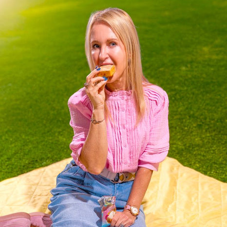 Woman enjoying a protein mini muffin outdoors